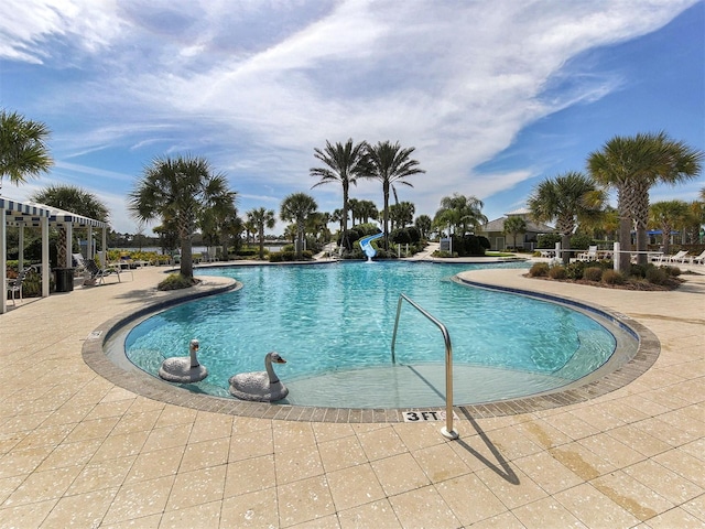 view of pool with a patio and a water slide