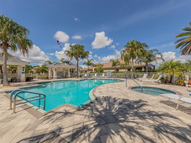 view of swimming pool with a gazebo, a patio, and a hot tub