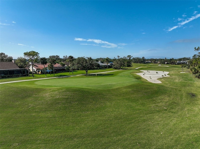 view of community featuring a lawn and golf course view