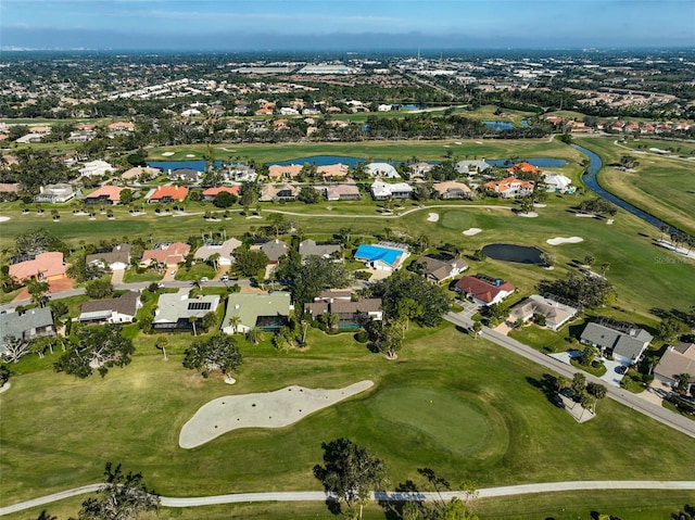 birds eye view of property with view of golf course, a water view, and a residential view