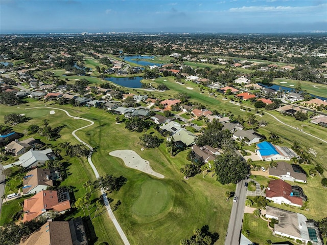 bird's eye view with golf course view, a water view, and a residential view