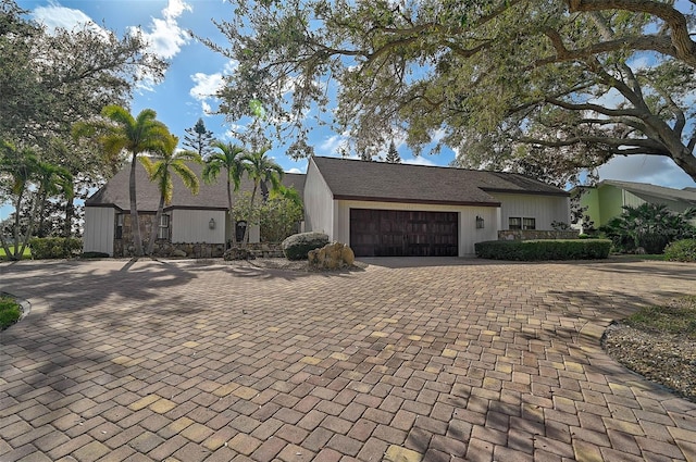 view of front of home featuring decorative driveway and an attached garage