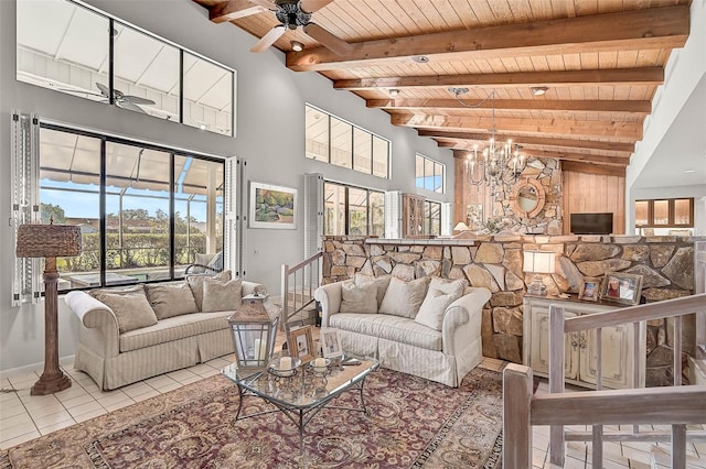 tiled living area featuring ceiling fan with notable chandelier, wooden ceiling, beamed ceiling, baseboards, and stairs