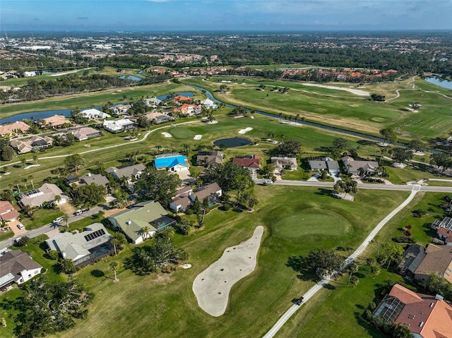 birds eye view of property with golf course view, a water view, and a residential view