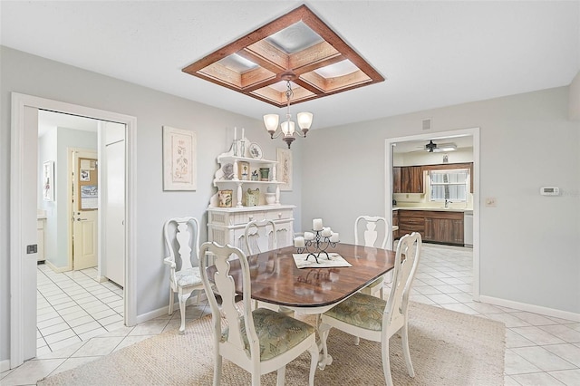 dining space with an inviting chandelier, baseboards, and light tile patterned flooring