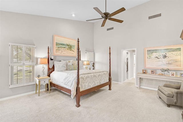 carpeted bedroom featuring ceiling fan, high vaulted ceiling, visible vents, and baseboards