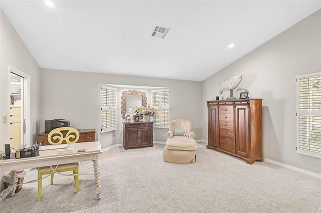 living area with lofted ceiling, carpet, and a wealth of natural light