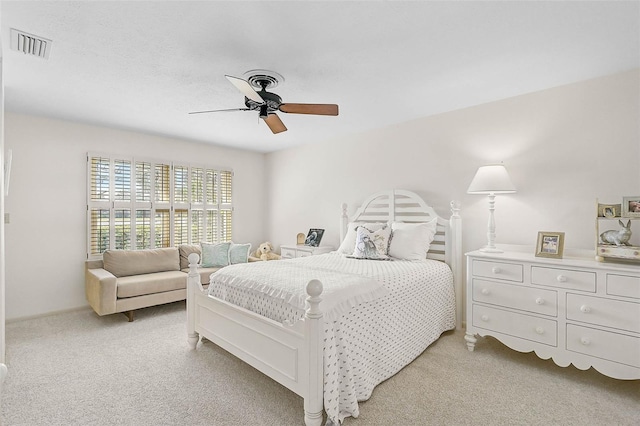 bedroom with light carpet, visible vents, and a ceiling fan