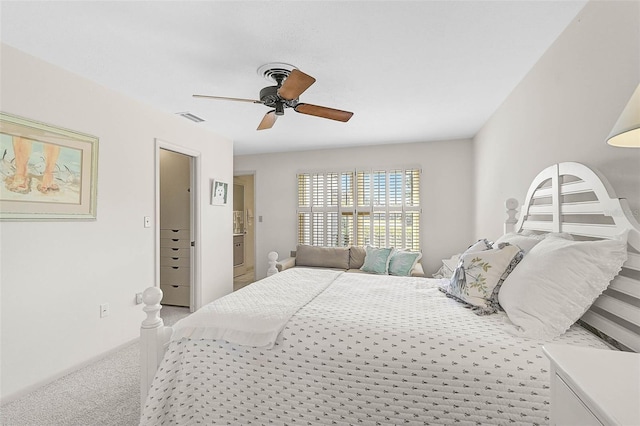 carpeted bedroom featuring ceiling fan and visible vents