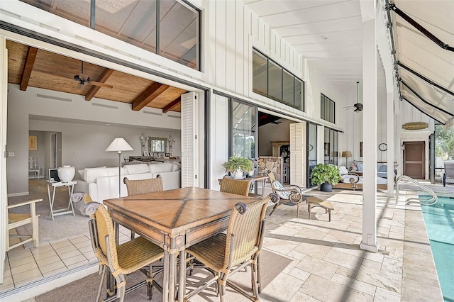 view of patio / terrace featuring an outdoor pool, a ceiling fan, and outdoor dining space