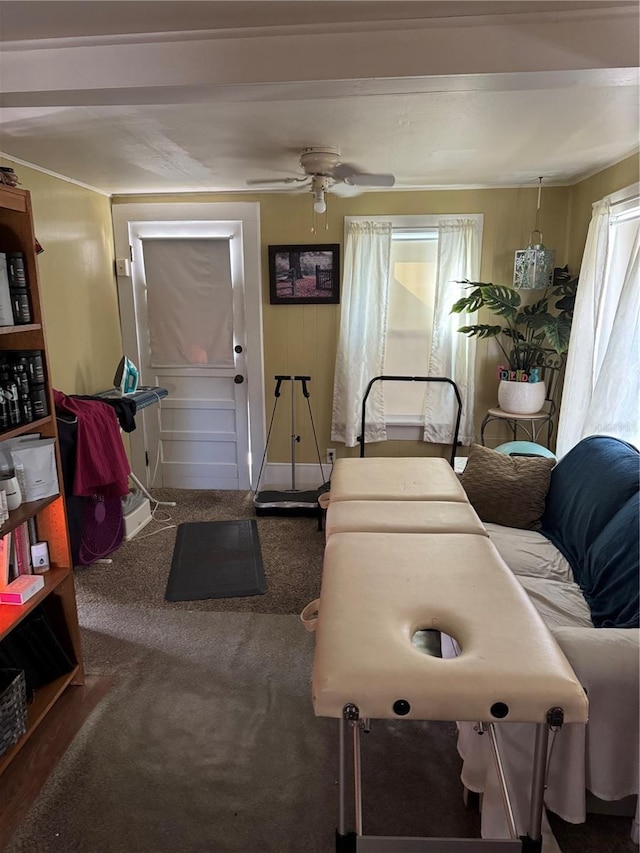 living room featuring dark carpet and ceiling fan