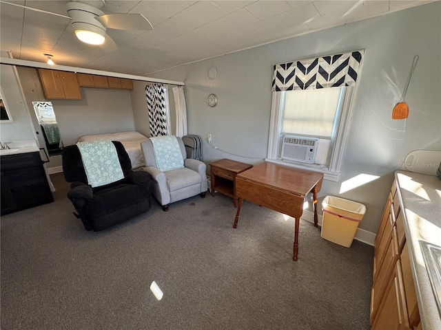 carpeted living room featuring ceiling fan and cooling unit