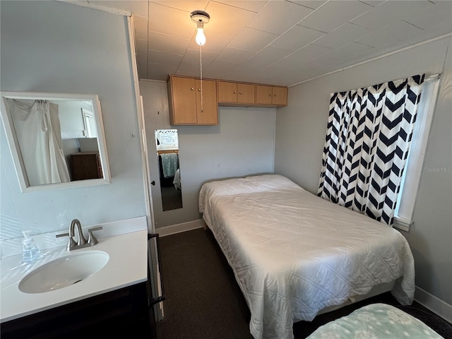 carpeted bedroom featuring sink