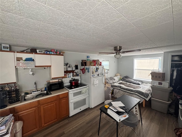 kitchen with ceiling fan, sink, dark hardwood / wood-style floors, and white appliances