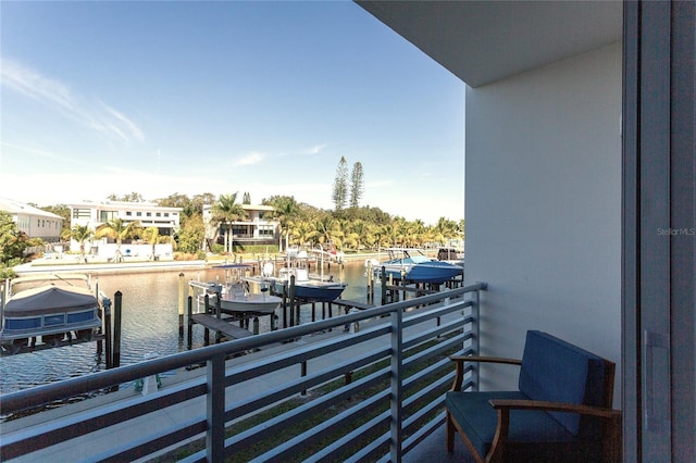 balcony with a boat dock and a water view