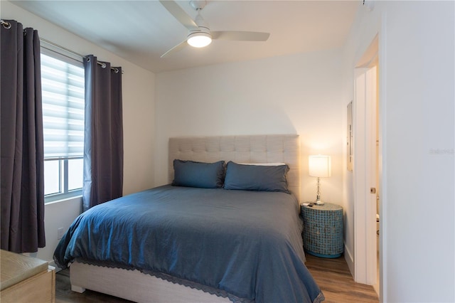 bedroom with ceiling fan and wood-type flooring