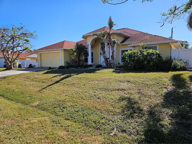 mediterranean / spanish-style house with a front lawn and a garage