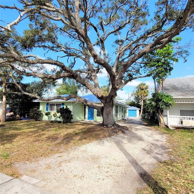 view of front of property with a garage and a front lawn