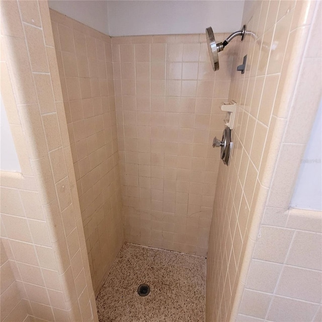 bathroom with a tile shower