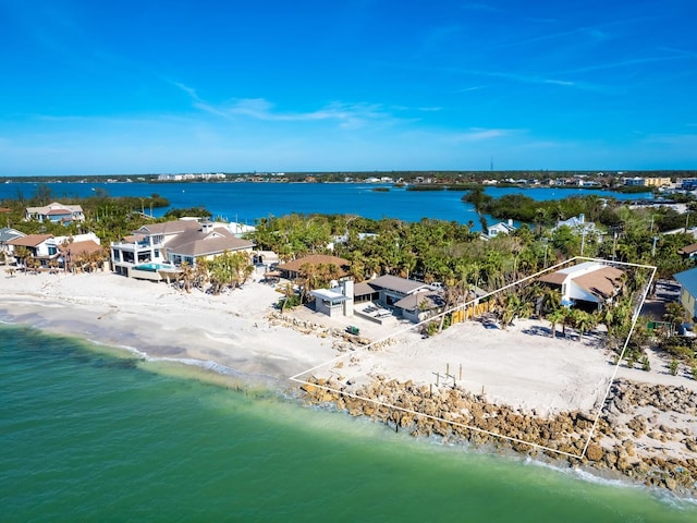 birds eye view of property with a water view and a view of the beach