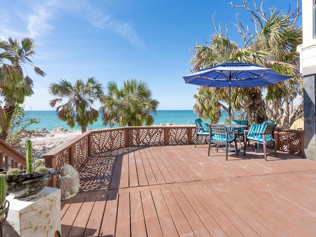 deck with a water view and a view of the beach