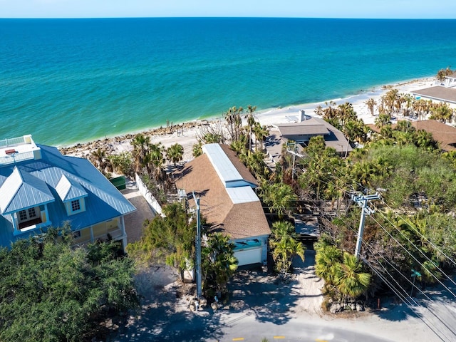 birds eye view of property featuring a beach view and a water view