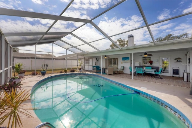 view of swimming pool with a lanai, ceiling fan, a patio area, and an outdoor hangout area