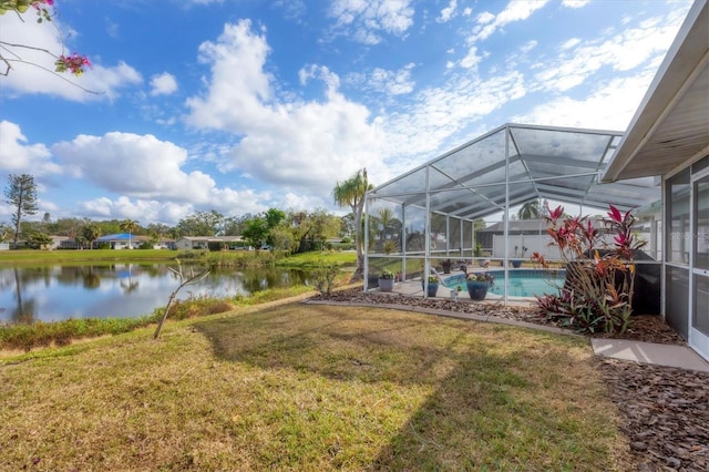 view of yard featuring a lanai and a water view