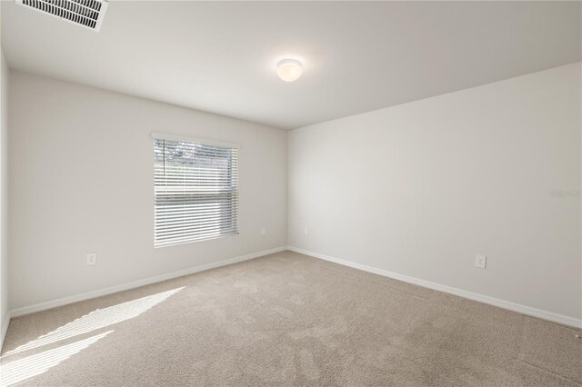 unfurnished room featuring carpet flooring