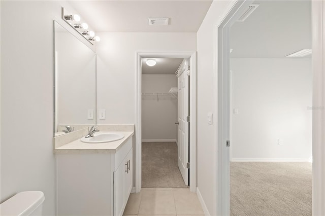 bathroom with tile patterned flooring, vanity, and toilet