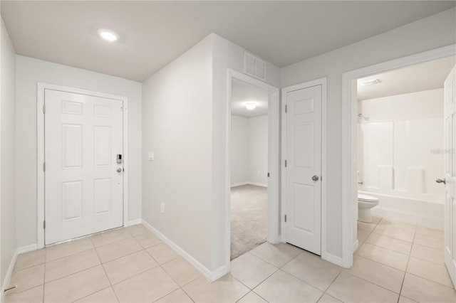 foyer entrance with light tile patterned floors