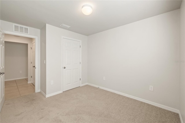 unfurnished bedroom featuring light colored carpet