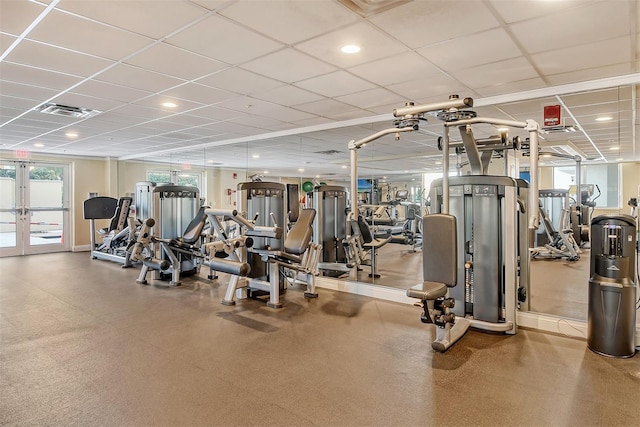 workout area featuring a drop ceiling and french doors