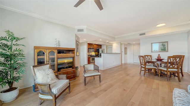 living room with light wood-type flooring, ceiling fan, and ornamental molding