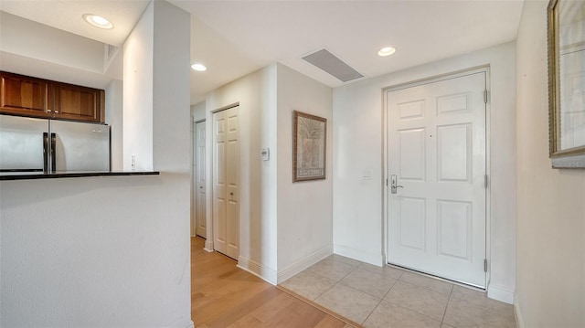 foyer with recessed lighting, visible vents, baseboards, and light wood-style floors