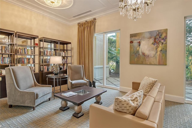 living area with visible vents, baseboards, a notable chandelier, and crown molding