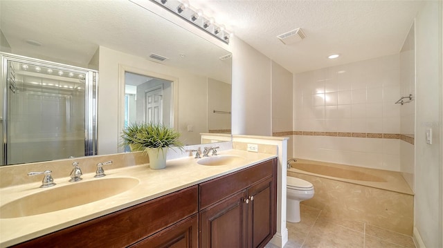 full bathroom featuring tile patterned flooring, vanity, separate shower and tub, toilet, and a textured ceiling