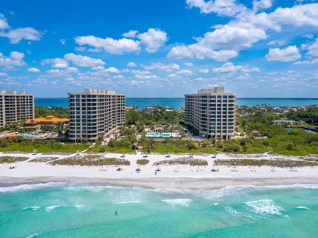 birds eye view of property featuring a water view and a view of the beach