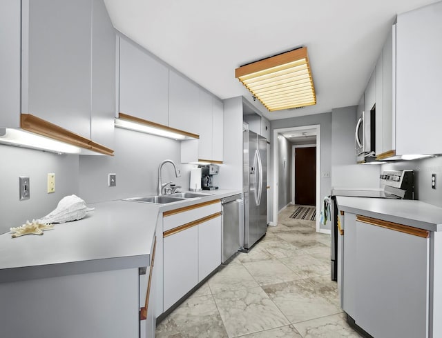 kitchen featuring white cabinets, sink, and appliances with stainless steel finishes