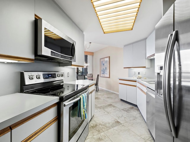 kitchen with white cabinets and appliances with stainless steel finishes