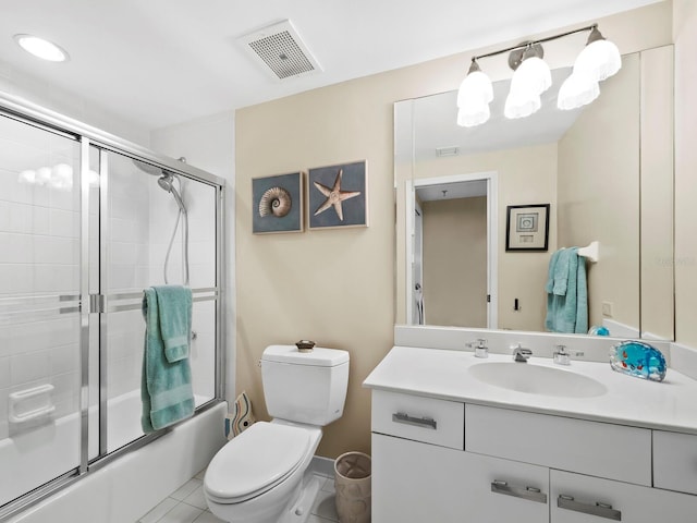 full bathroom featuring tile patterned floors, vanity, toilet, and combined bath / shower with glass door