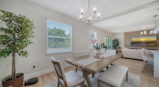 dining space featuring a chandelier and light wood-type flooring