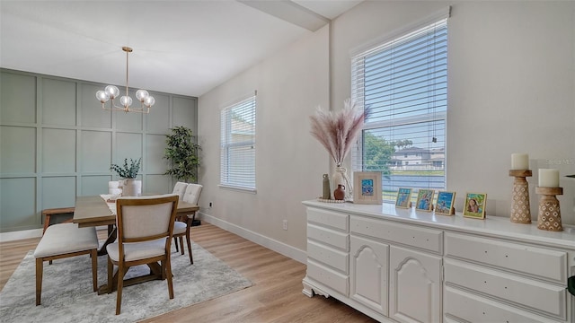 dining space featuring an inviting chandelier and light hardwood / wood-style flooring