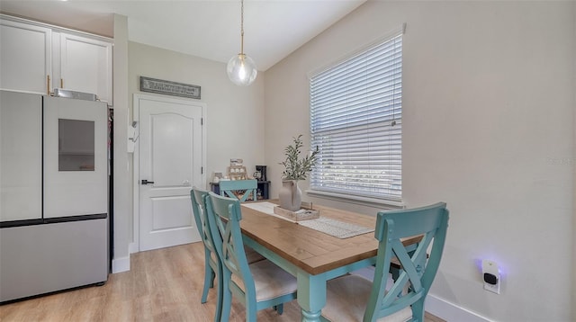 dining space featuring light wood-type flooring