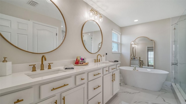 bathroom featuring vanity and shower with separate bathtub