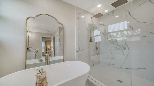 bathroom featuring plenty of natural light, vanity, and independent shower and bath