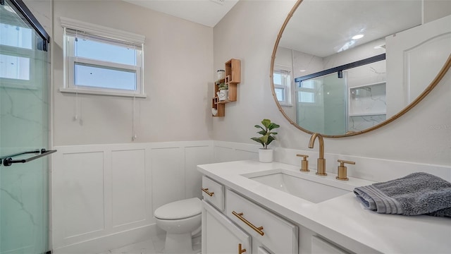 bathroom with vanity, toilet, and walk in shower