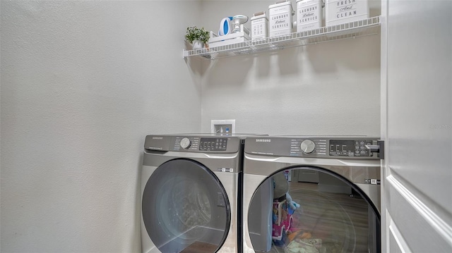 clothes washing area featuring washer and clothes dryer