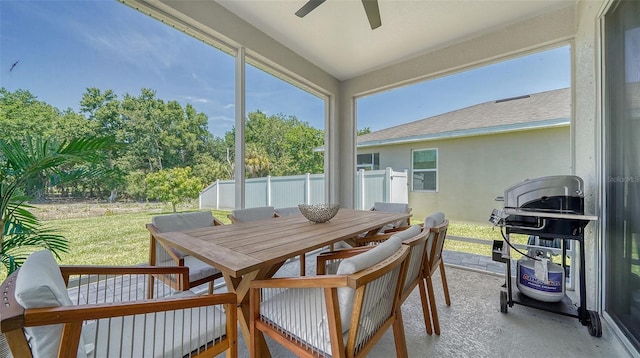 sunroom featuring ceiling fan