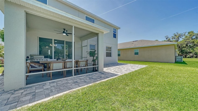 back of house with a lawn, a patio area, and ceiling fan